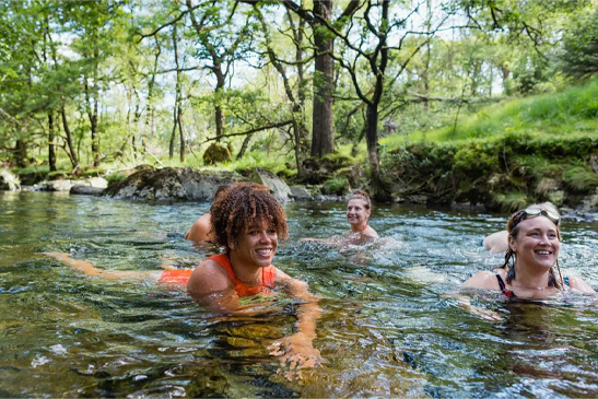 Swimmers enjoying a safe wild swim in a UK river