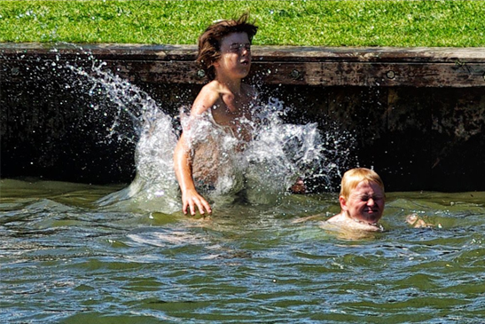 Group of wild swimmers enjoying a river swim in the UK countryside